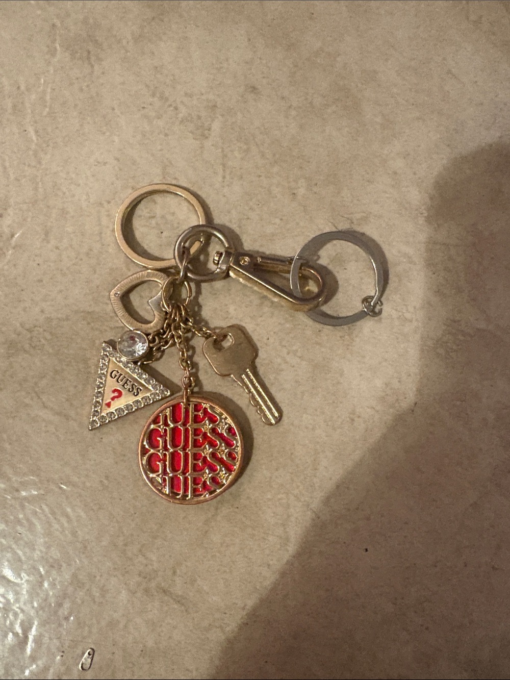 GUESS Gold-Tone Keychain with Red Logo Disc and Triangle Charm